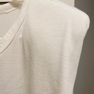 White muscle shirt with shoulder pads.